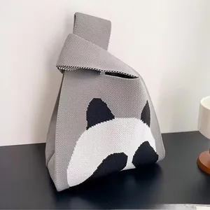Detail shot of the thick knitted fabric and cute panda pattern on the grey tote bag