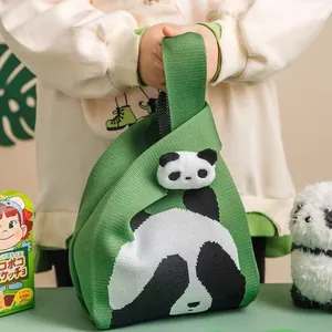 Green knitted panda tote bag with large panda pattern and plush mascot charm