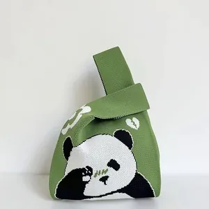 Green knit panda tote bag with unique knot handle design and jacquard heart pattern
