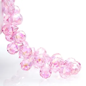 Macro detail of faceted pink teardrop crystal beads with sparkling light refraction