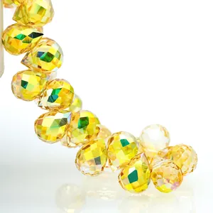 Macro detail of faceted yellow K9 crystal teardrop beads with iridescent AB coating