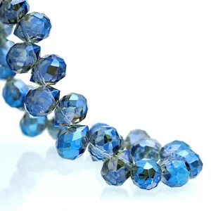 Macro detail of faceted deep blue K9 crystal teardrop beads arranged in an S-curve