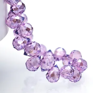 Macro shot of faceted purple crystal teardrop beads with brilliant light reflection