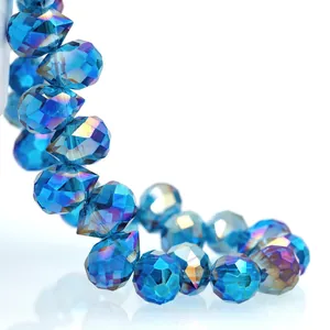 Macro shot of dark blue faceted K9 crystal teardrop beads with iridescent AB coating