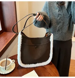 Detail of suede bucket bag featuring plush faux fur trim and elegant metal button closure