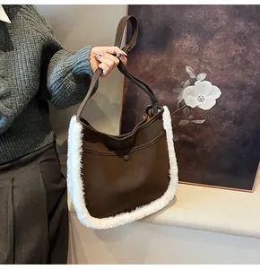 Detail of a brown suede tote bag with white faux fur trim and snap closure for winter