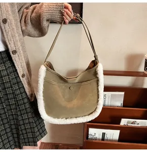 Detail of olive green suede bucket bag featuring white faux shearling trim and magnetic closure