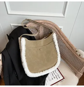 Detail of khaki suede bucket bag with white faux fur trim on a vintage wooden chair