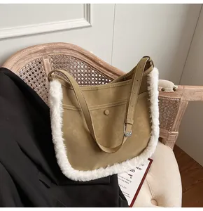 Close-up of khaki faux suede bucket bag with fluffy white plush trim and metal buckle