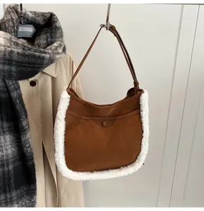 Detail of dark brown faux suede bucket bag with white fleece trim and slim shoulder strap