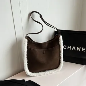 Dark brown faux suede bucket bag with plush white fur trim and adjustable strap for women