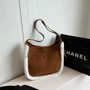 Brown faux suede bucket bag with white faux fur trim and adjustable shoulder strap