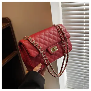 Detailed close-up of the red quilted leather texture and golden metal twist lock closure