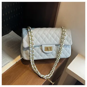Close-up of diamond-quilted stitching and golden twist-lock on luxury leather bag