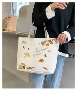 Detail of white canvas tote bag with autumn harvest prints and hedgehog illustration