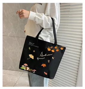 Detail of black canvas tote bag with Autumn Harvest print and large storage capacity