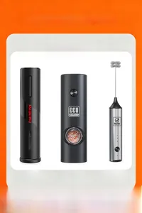 Kitchen set with electric wine opener, pepper grinder and milk frother on orange background