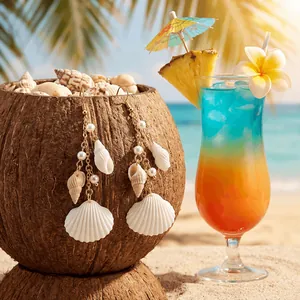Detail of seashell and pearl tassel earrings hanging on a tropical coconut shell