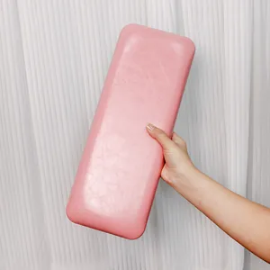 Close-up of pink PU leather nail arm rest with soft texture and rounded edges
