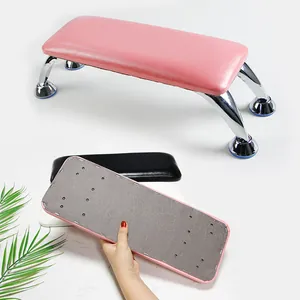 Detail of pink nail hand rest showing smooth PU leather finish and sturdy U-shaped metal stand