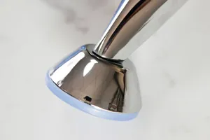 Close-up of chrome metal furniture leg with blue translucent anti-slip silicone pad