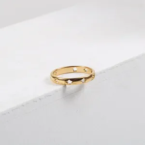 Detailed view of cutout star patterns on a curved 18k gold-plated titanium steel ring
