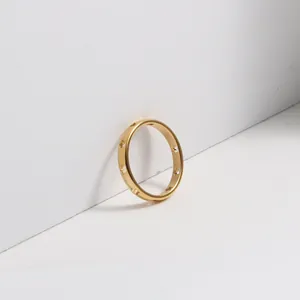 Macro detail of 18k gold plated stainless steel ring with hollow star cutouts