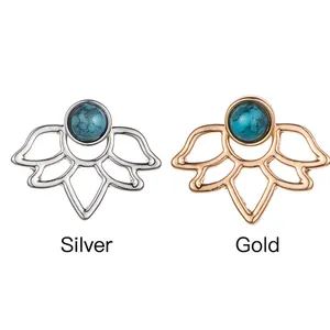 Detail view of hollow lotus stud earrings in silver and gold finishes with blue stones