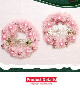 Detail of pink Christmas wreath with decorative balls and a Merry Christmas sign