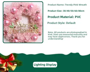 Detail of pink Christmas wreath with shiny baubles and Merry Christmas sign