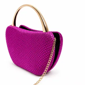 Fuchsia heart-shaped evening clutch bag with golden metal handle and chain strap