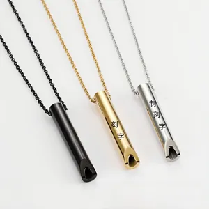 Three polished cylindrical pendant necklaces in black, gold, and silver stainless steel