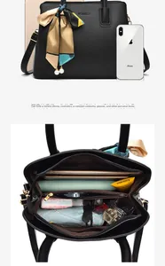 Detail view of large black lychee leather handbag showing spacious interior organization