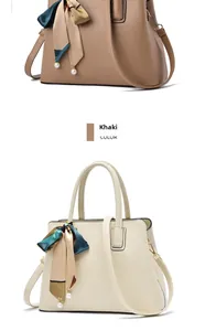 Detail of elegant handbags in khaki and beige with silk scarf and pearl decoration