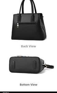 Detail view of the black handbag back zipper pocket and reinforced bottom with metal studs
