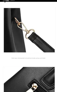 Detail of high-gloss gold hardware hooks and black synthetic leather texture on handbag