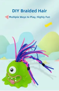 Detail view of a green one-eyed monster toy with DIY braided pink and blue hair
