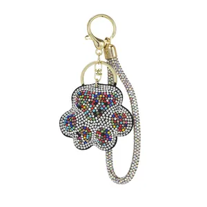 Close-up of sparkling crystal-encrusted bear paw keychain with gold-plated lobster clasp