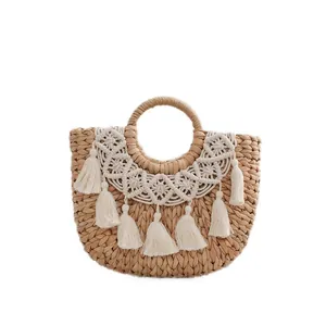 Handmade woven straw handbag with white lace trim and tassels for beach vacations