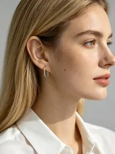 Close-up of S925 sterling silver U-shaped hoop earring with bead texture on a model