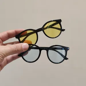 Kids vintage round frame sunglasses in black finish with yellow and blue lenses