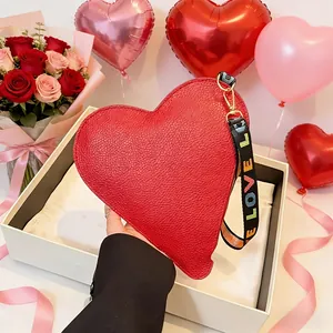 Red heart-shaped leather handbag with LOVE letter strap and gift box and roses