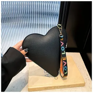 Fashionable black heart-shaped handbag with pebbled leather and colorful LOVE strap