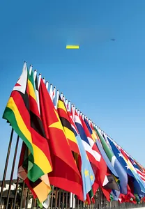Macro low-angle view of 2026 World Cup polyester flags fluttering against a clear blue sky