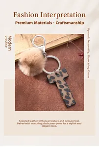 Detail of leopard print T-letter keychain with soft tan faux fur pom pom and silver clasp