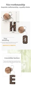 Detail view of leopard print keychain letters with faux fur pom pom and zinc alloy clasp