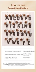 Detail overview of leopard print leather alphabet keychains with faux fur pom poms