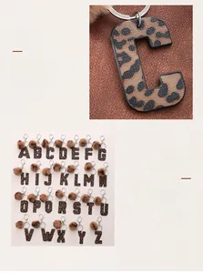 Macro shot of leopard print PU leather initial C with matching faux fur pom pom keychain