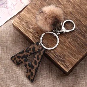Western style leopard print letter A keychain with fluffy brown faux fur pom pom