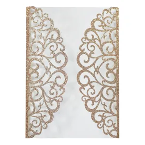 Detail of laser-cut glitter engagement invitation pocket with ornate floral scroll patterns